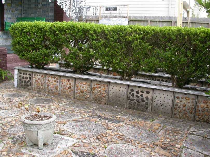 the marble- and stone-studded concrete patio and planter box